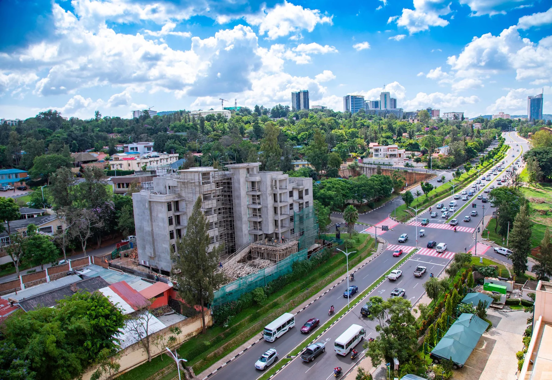 An elevated view of a Kigali city street, buildings and trees in 2018.