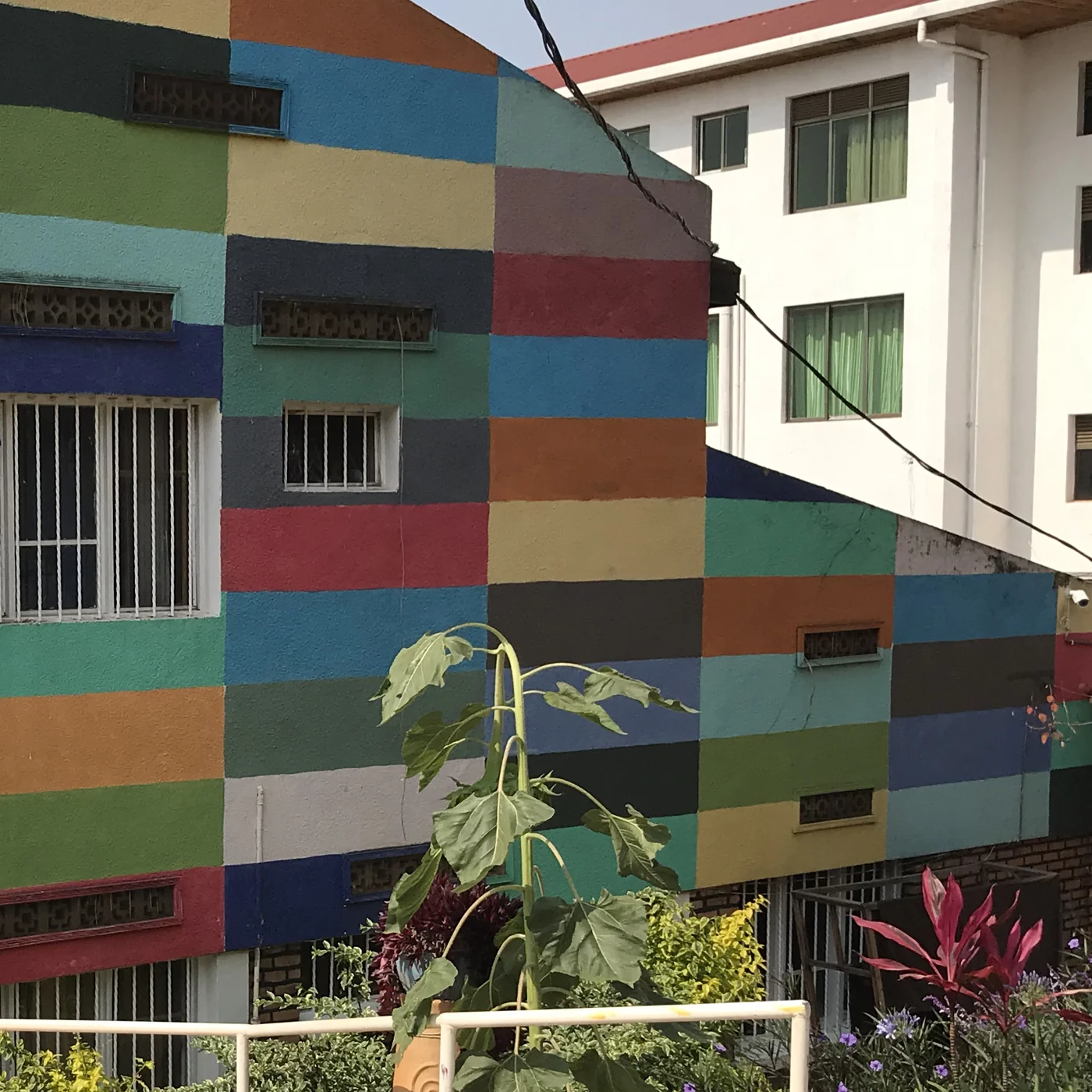 A close view of the painted exterior and windows at Inema Arts Center in Kigali.