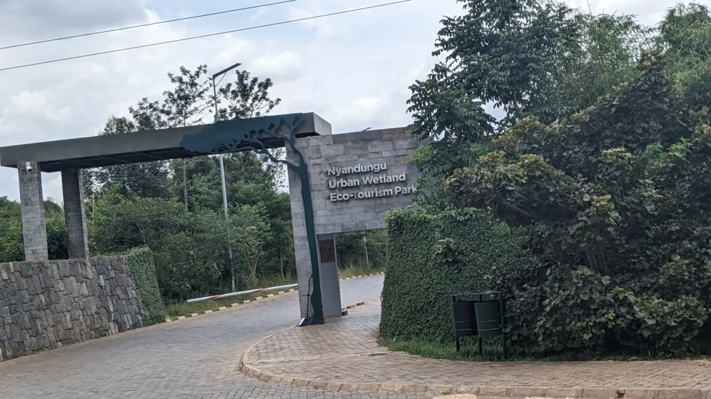 The entrance path and sign at Nyandungu Urban Wetland Eco-Tourism Park.